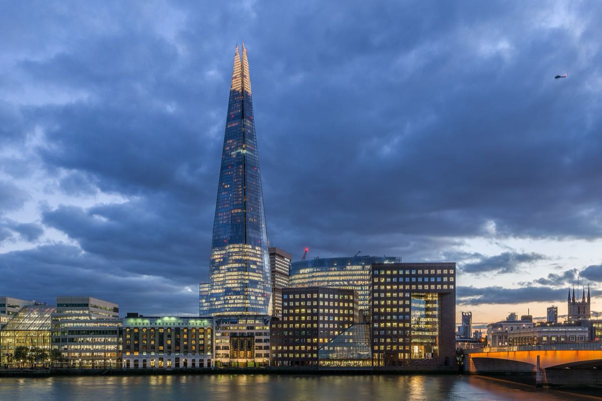 The Shard, home of Aqua Shard, rising above London Bridge at sunset