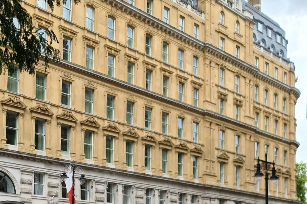 The curved stone front of the Corinthia hotel on Whitehall Place